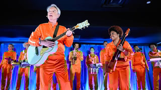 Image for David Byrne Brings a Wave of Orange Tracksuits to Perform &#8216;What Is The Reason for It?&#8217; on &#8216;Fallon&#8217;